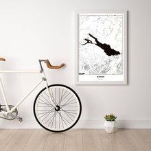 Lade das Bild in den Galerie-Viewer, Bodensee Light Poster - Minimal - Vorschau in einem hellen Zimmer mit Fahrrad an Wand angelehnt
