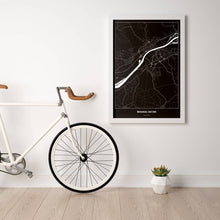 Lade das Bild in den Galerie-Viewer, Braunau am Inn Dark Poster - Minimal - Vorschau in einem hellen Zimmer mit Fahrrad an Wand angelehnt