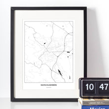 Lade das Bild in den Galerie-Viewer, Deutschlandsberg Light Poster - Minimal - Vorschau vor weißer Wand zusammen mit Dekoartikeln