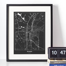 Lade das Bild in den Galerie-Viewer, Erlangen Dark Poster - Minimal - Vorschau vor weißer Wand zusammen mit Dekoartikeln