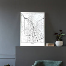 Lade das Bild in den Galerie-Viewer, Graz Light Poster - Minimal - Vorschau in einem eleganten Zimmer mit Sessel und grauer Wand