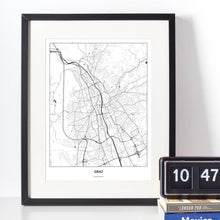 Lade das Bild in den Galerie-Viewer, Graz Light Poster - Minimal - Vorschau vor weißer Wand zusammen mit Dekoartikeln