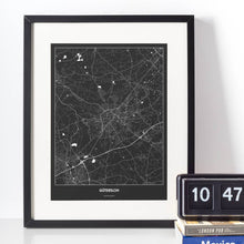 Lade das Bild in den Galerie-Viewer, Gütersloh Dark Poster - Minimal - Vorschau vor weißer Wand zusammen mit Dekoartikeln