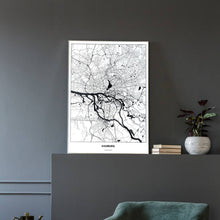 Lade das Bild in den Galerie-Viewer, Hamburg Light Poster - Minimal - Vorschau in einem eleganten Zimmer mit Sessel und grauer Wand