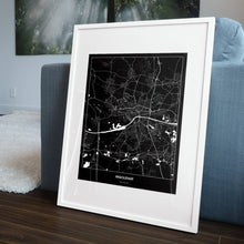 Lade das Bild in den Galerie-Viewer, Ingolstadt Dark Poster - Minimal - Vorschau in einem Wohnzimmer am Boden aufgestellt und auf der Couch angelehnt