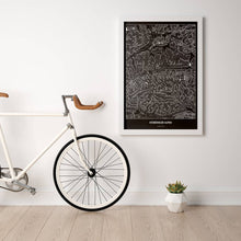 Lade das Bild in den Galerie-Viewer, Kitzbüheler Alpen Dark Poster - Minimal - Vorschau in einem hellen Zimmer mit Fahrrad an Wand angelehnt