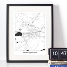 Lade das Bild in den Galerie-Viewer, Klagenfurt am Wörthersee Light Poster - Minimal - Vorschau vor weißer Wand zusammen mit Dekoartikeln