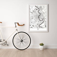 Lade das Bild in den Galerie-Viewer, Köln Light Poster - Minimal - Vorschau in einem hellen Zimmer mit Fahrrad an Wand angelehnt