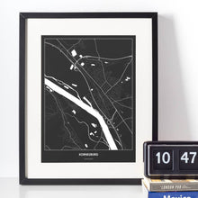 Lade das Bild in den Galerie-Viewer, Korneuburg Dark Poster - Minimal - Vorschau vor weißer Wand zusammen mit Dekoartikeln