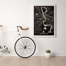 Lade das Bild in den Galerie-Viewer, Ludwigshafen am Rhein Dark Poster - Minimal - Vorschau in einem hellen Zimmer mit Fahrrad an Wand angelehnt