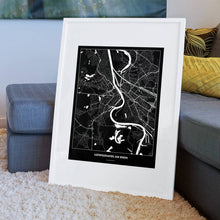 Lade das Bild in den Galerie-Viewer, Ludwigshafen am Rhein Dark Poster - Minimal - Vorschau am Boden auf Couch angelehnt in einem Wohnzimmer