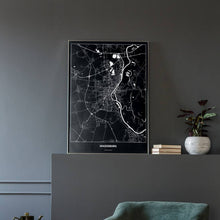 Lade das Bild in den Galerie-Viewer, Magdeburg Dark Poster - Minimal - Vorschau in einem eleganten Zimmer mit Sessel und grauer Wand