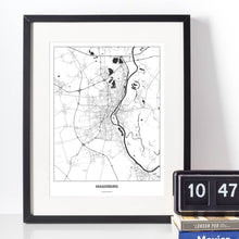 Lade das Bild in den Galerie-Viewer, Magdeburg Light Poster - Minimal - Vorschau vor weißer Wand zusammen mit Dekoartikeln