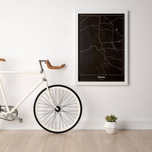 Lade das Bild in den Galerie-Viewer, Mödling Dark Poster - Minimal - Vorschau in einem hellen Zimmer mit Fahrrad an Wand angelehnt