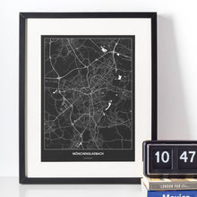 Lade das Bild in den Galerie-Viewer, Mönchengladbach Dark Poster - Minimal - Vorschau vor weißer Wand zusammen mit Dekoartikeln