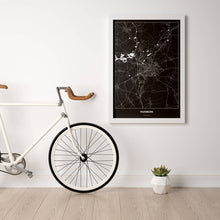 Lade das Bild in den Galerie-Viewer, Paderborn Dark Poster - Minimal - Vorschau in einem hellen Zimmer mit Fahrrad an Wand angelehnt