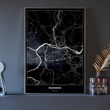 Lade das Bild in den Galerie-Viewer, Regensburg Dark Poster - Minimal - Vorschau neben Dekoartikeln vor dunkelgrauer Wand