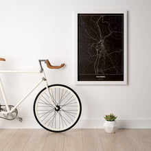 Lade das Bild in den Galerie-Viewer, Wolfsberg Dark Poster - Minimal - Vorschau in einem hellen Zimmer mit Fahrrad an Wand angelehnt
