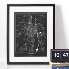 Lade das Bild in den Galerie-Viewer, Augsburg Dark Poster - Minimal - Vorschau vor weißer Wand zusammen mit Dekoartikeln
