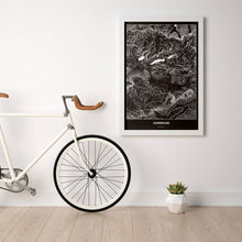 Lade das Bild in den Galerie-Viewer, Ausseerland Dark Poster - Minimal - Vorschau in einem hellen Zimmer mit Fahrrad an Wand angelehnt
