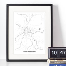 Lade das Bild in den Galerie-Viewer, Feldkirchen in Kärnten Light Poster - Minimal - Vorschau vor weißer Wand zusammen mit Dekoartikeln
