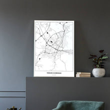 Lade das Bild in den Galerie-Viewer, Freiburg im Breisgau Light Poster - Minimal - Vorschau in einem eleganten Zimmer mit Sessel und grauer Wand

