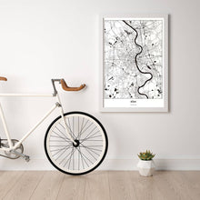 Lade das Bild in den Galerie-Viewer, Köln Light Poster - Minimal - Vorschau in einem hellen Zimmer mit Fahrrad an Wand angelehnt
