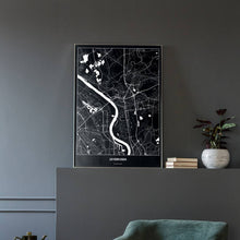 Lade das Bild in den Galerie-Viewer, Leverkusen Dark Poster - Minimal - Vorschau in einem eleganten Zimmer mit Sessel und grauer Wand
