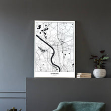 Lade das Bild in den Galerie-Viewer, Leverkusen Light Poster - Minimal - Vorschau in einem eleganten Zimmer mit Sessel und grauer Wand
