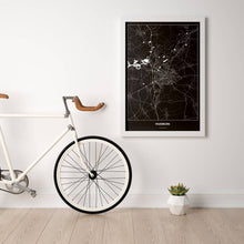 Lade das Bild in den Galerie-Viewer, Paderborn Dark Poster - Minimal - Vorschau in einem hellen Zimmer mit Fahrrad an Wand angelehnt
