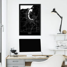Lade das Bild in den Galerie-Viewer, Rostock Dark Poster - Minimal - Vorschau über Schreibtisch vor einer weißen Wand

