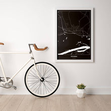 Lade das Bild in den Galerie-Viewer, Stockerau Dark Poster - Minimal - Vorschau in einem hellen Zimmer mit Fahrrad an Wand angelehnt
