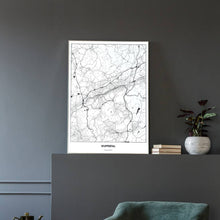 Lade das Bild in den Galerie-Viewer, Wuppertal Light Poster - Minimal - Vorschau in einem eleganten Zimmer mit Sessel und grauer Wand
